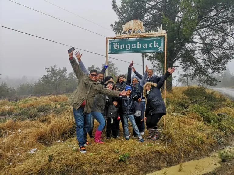 Visitors gathered at the Hogsback sign during a snowfall