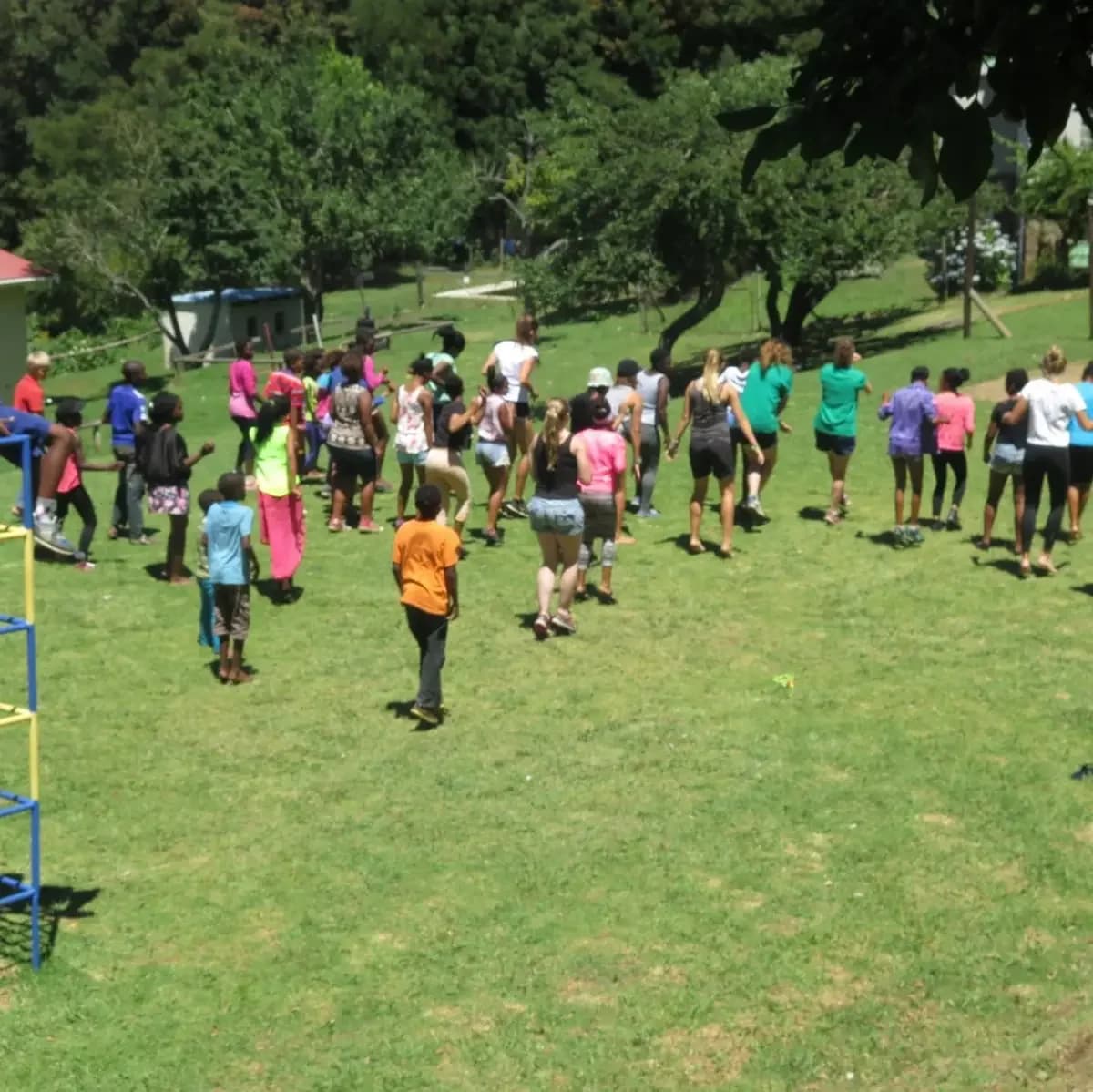 A group taking part in outdoor activities on the lawn at Hobbiton