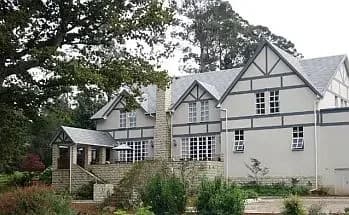 The Hogsback Inn buildings among established trees