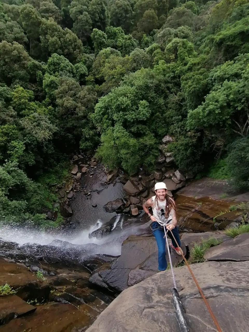 A participant ascending during a guided waterfall abseiling activity