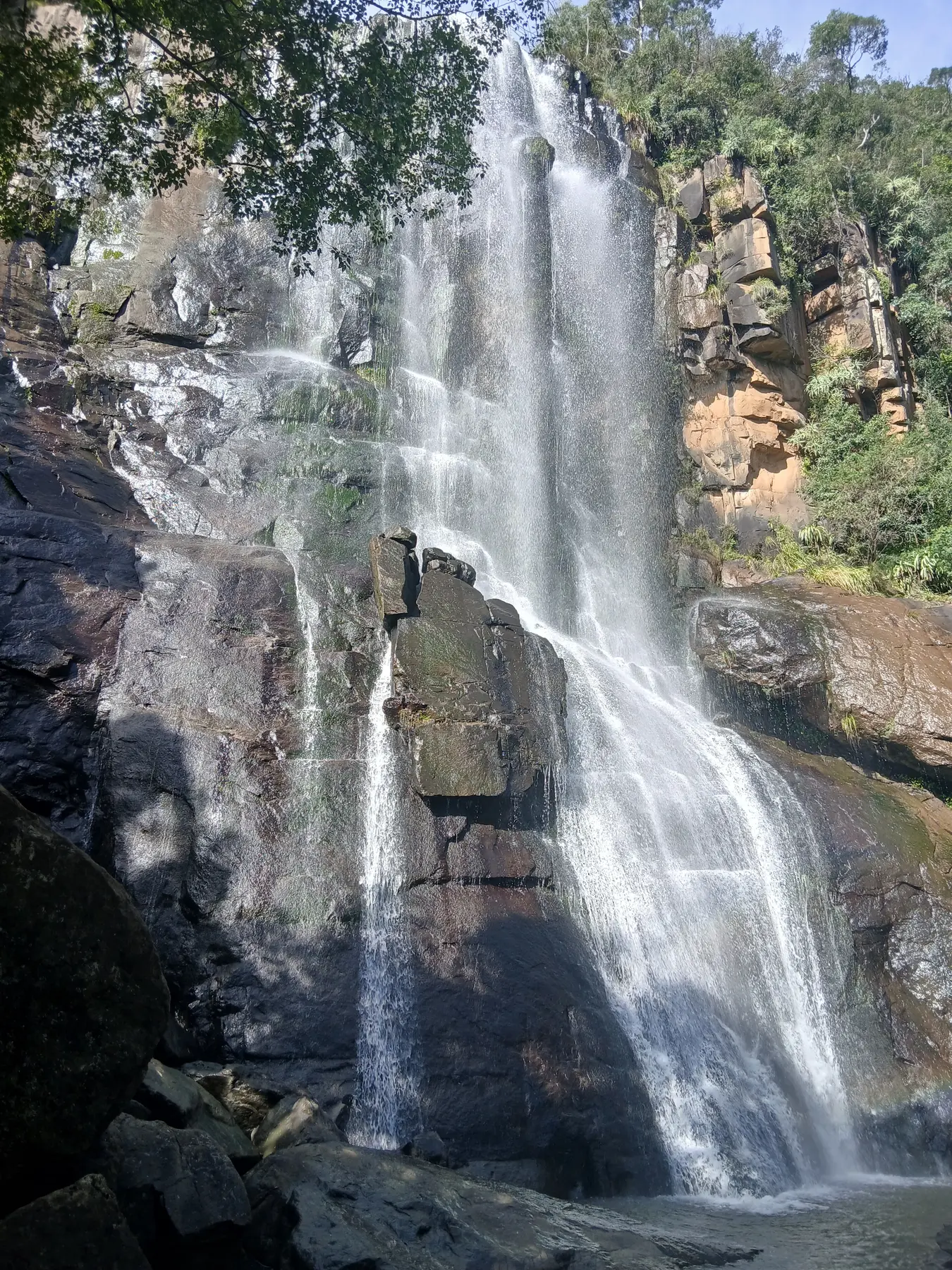 Water and rock formations on the face of Madonna and Child Waterfall
